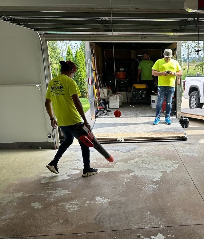 Contractor learning concrete surface preparation using dust collection equipment during epoxy coatings training with Action Industrial Coatings