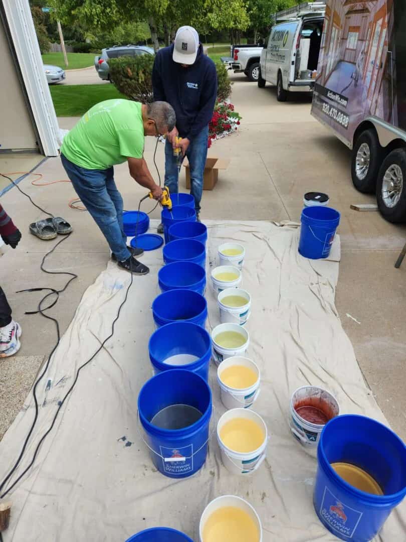 Hands-on epoxy coatings training showing contractors mixing coating materials during an Action Industrial Coatings class