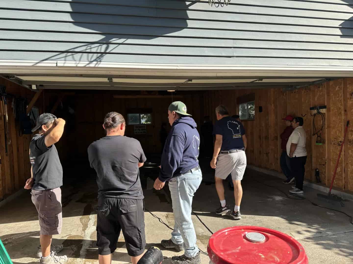 Contractors learning concrete surface preparation during an epoxy floor coatings training class