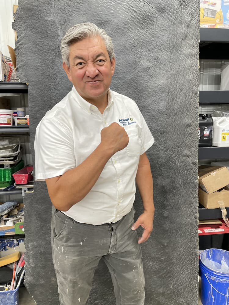 Ruben, lead instructor at Action Industrial Coatings, demonstrating epoxy and polyaspartic coating techniques during installer training