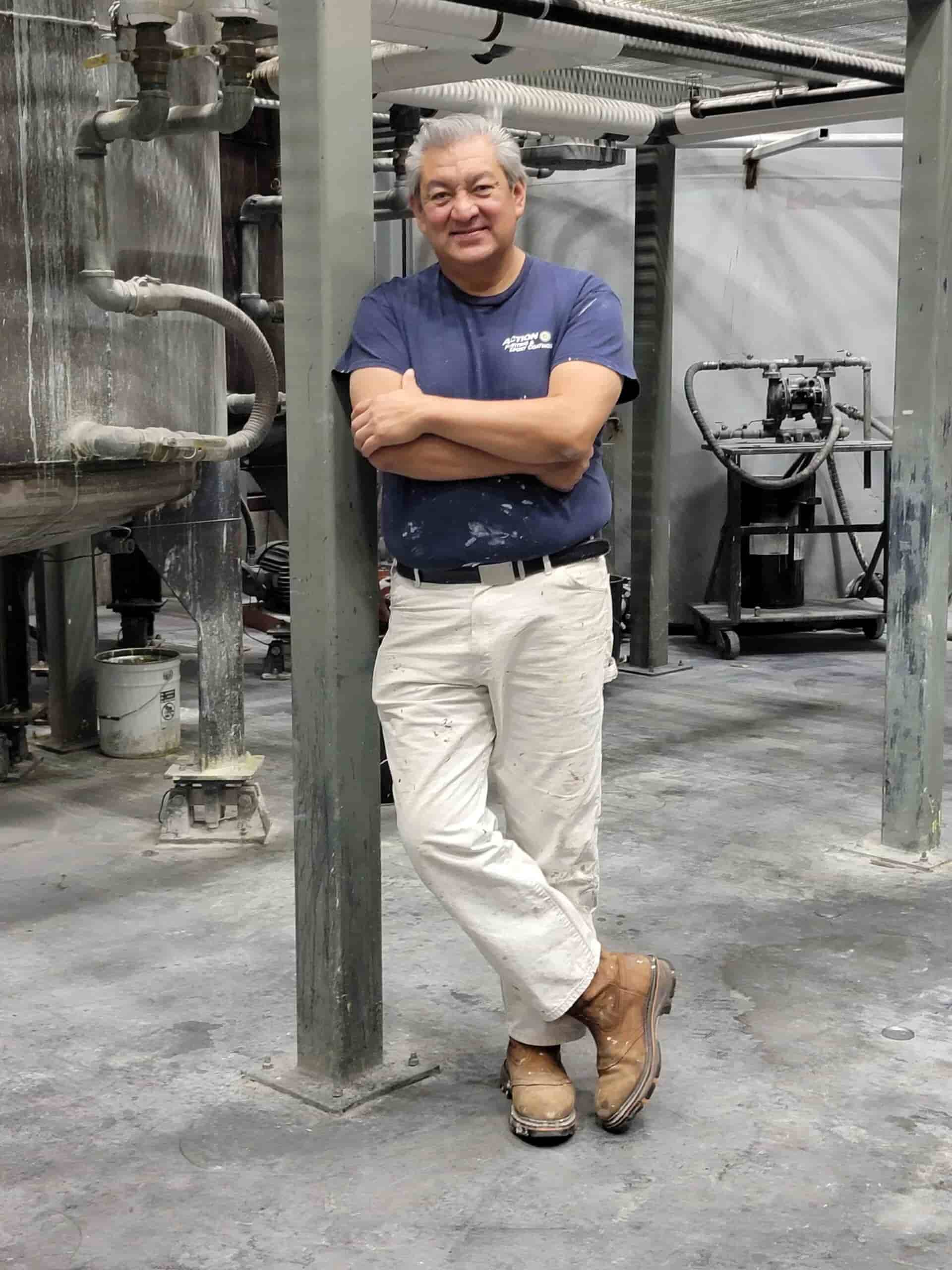 Ruben Contreras standing inside a polyurea coatings production facility used for contractor training and system development